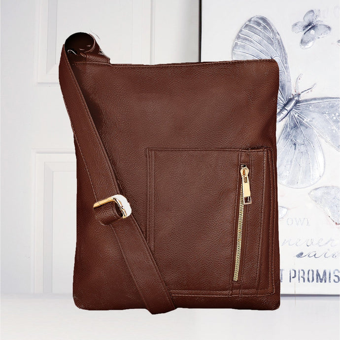 Brown leather crossbody bag with gold zipper on a white surface