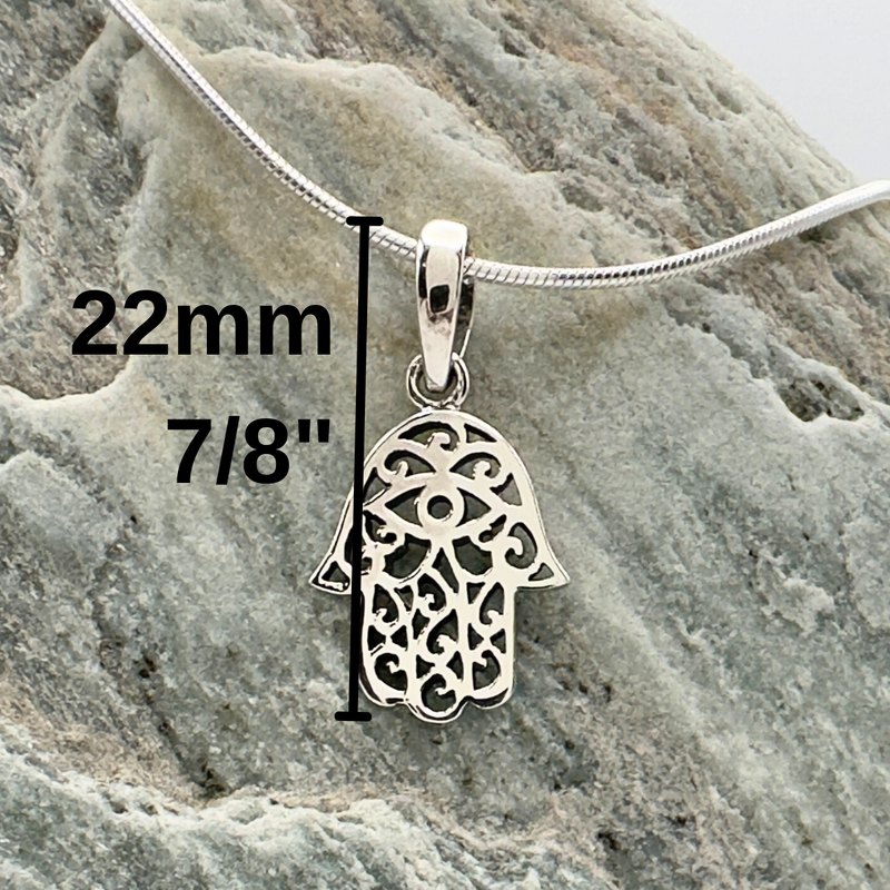 Load image into Gallery viewer, Silver Hamsa pendant with measurements on a stone surface
