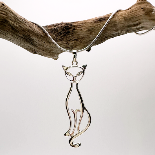 Cat-shaped pendant on a chain against a white background