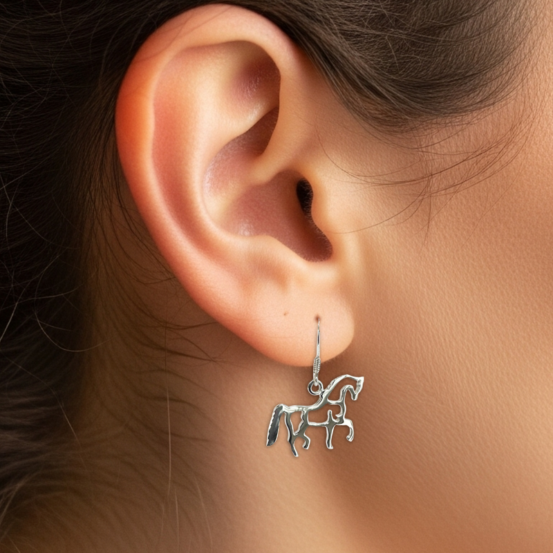 Load image into Gallery viewer, Close-up of an ear wearing a silver unicorn earring with a blurred background
