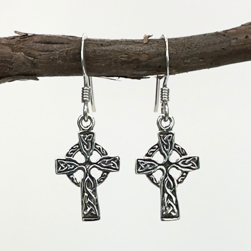 Load image into Gallery viewer, Silver Celtic cross earrings hanging on a branch with a white background
