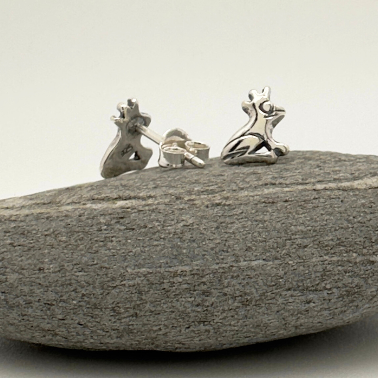 Load image into Gallery viewer, Silver earrings on a gray stone against a white background
