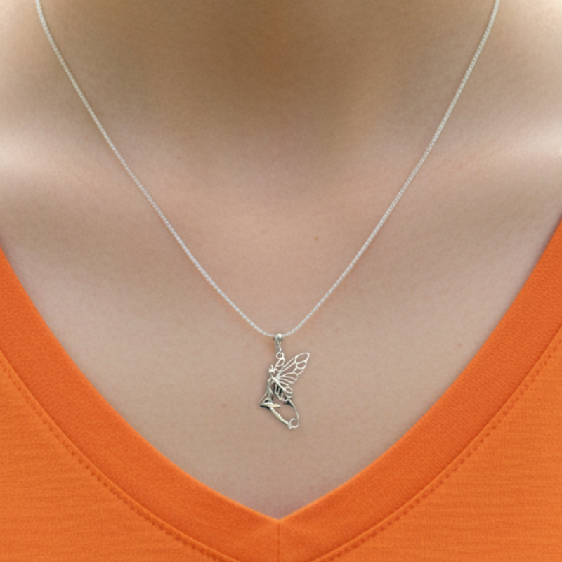 Load image into Gallery viewer, Silver fairy pendant necklace on a person wearing an orange top.
