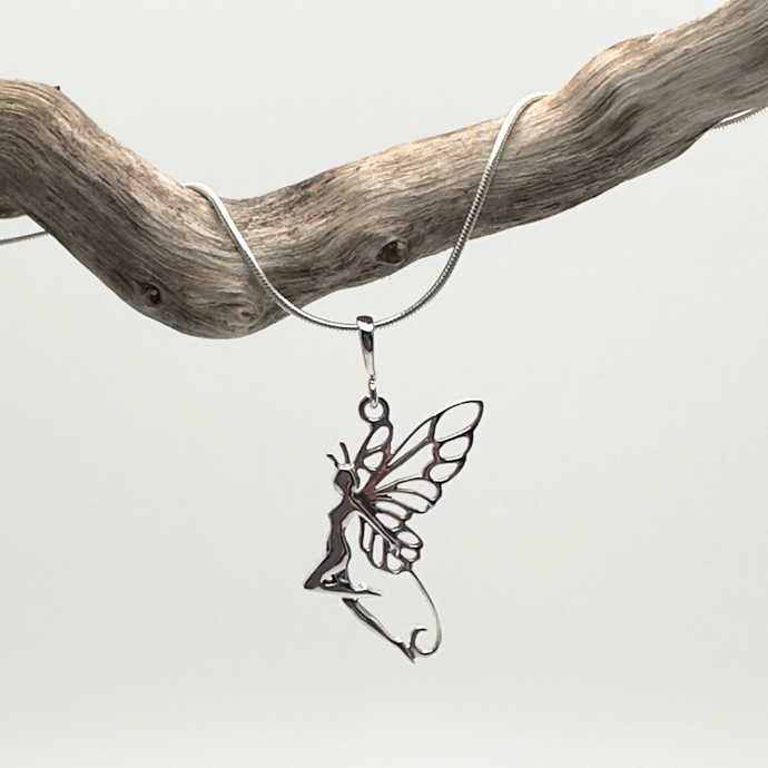 Silver fairy pendant on a chain against a light gray background
