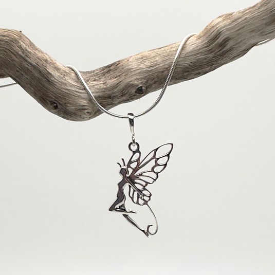 Silver fairy pendant on a chain against a light gray background