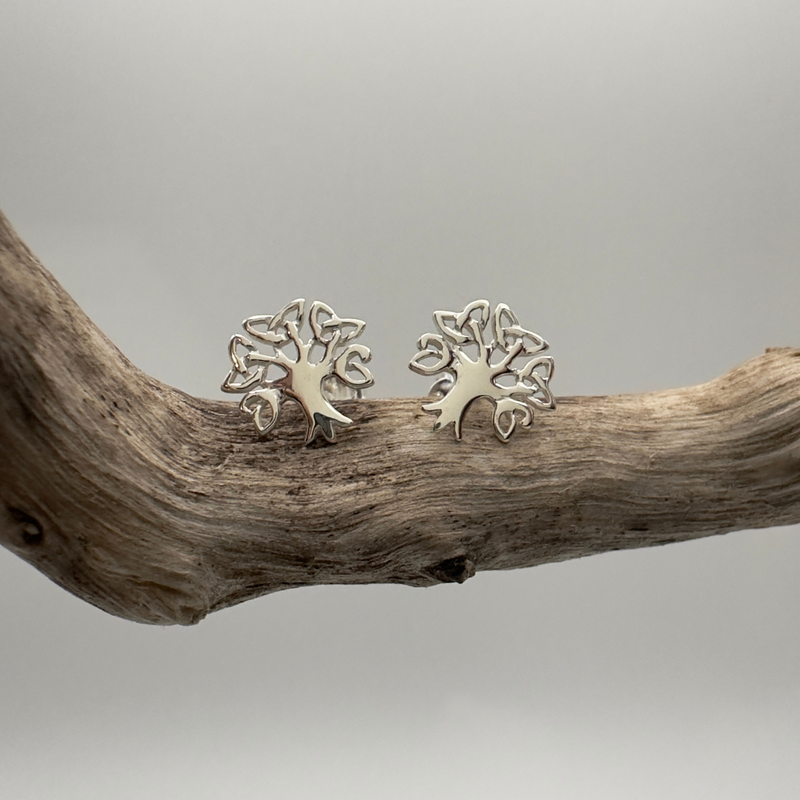Load image into Gallery viewer, Pair of silver tree-shaped earrings on a wooden branch with a neutral background

