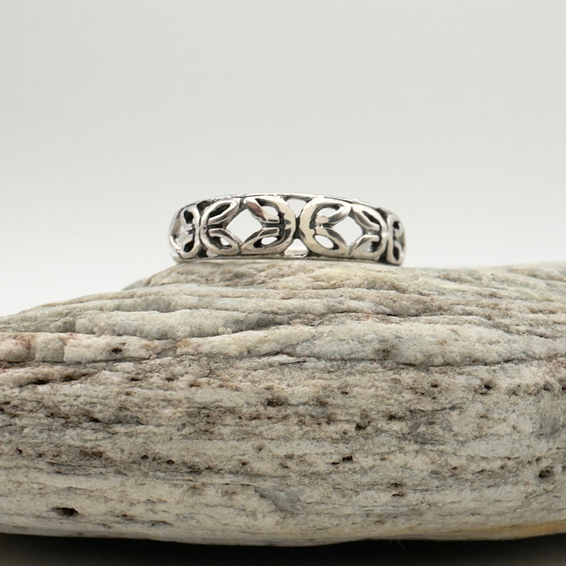 Load image into Gallery viewer, Silver ring with intricate design on a textured stone surface
