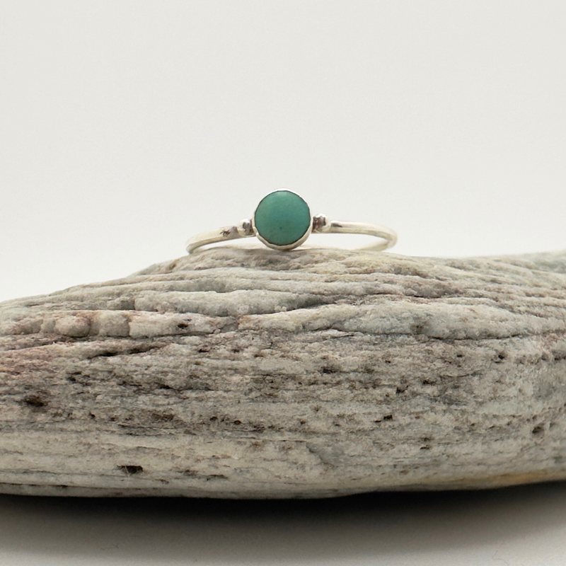 Load image into Gallery viewer, Ring with a green stone on a piece of driftwood against a white background
