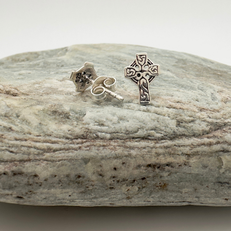 Load image into Gallery viewer, Silver cross earrings on a stone surface

