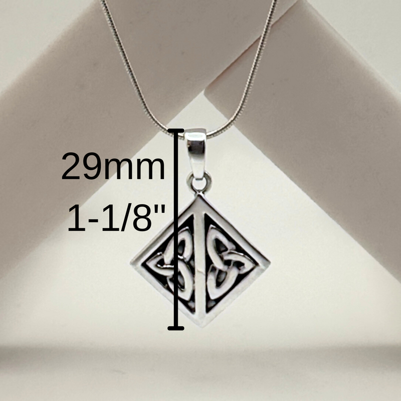 Load image into Gallery viewer, Silver pendant with measurement details on a beige background

