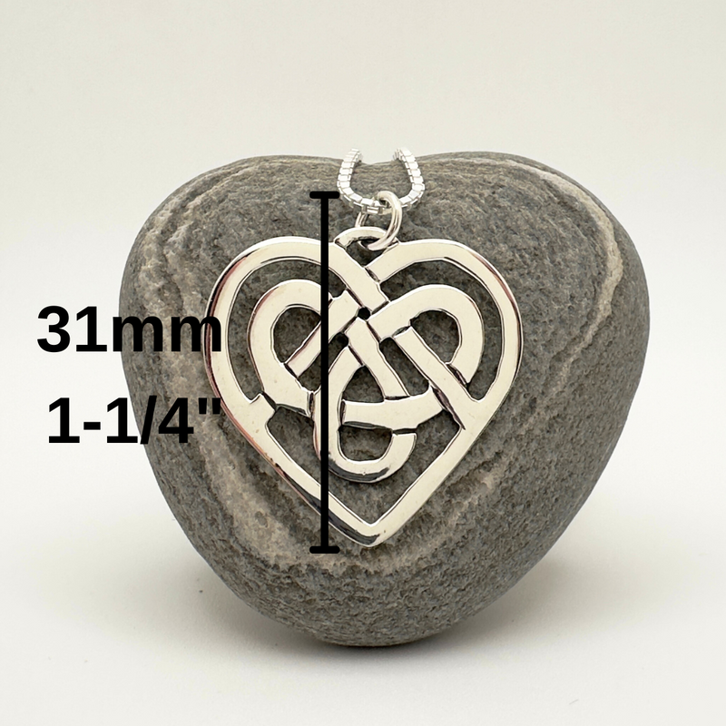 Load image into Gallery viewer, Heart-shaped pendant with Celtic knot design on a gray stone, measurement text overlay.
