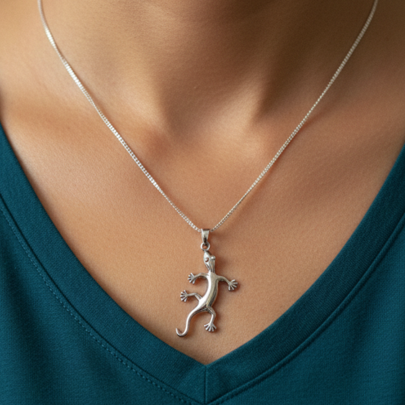 Load image into Gallery viewer, Silver lizard pendant necklace on a person wearing a teal top
