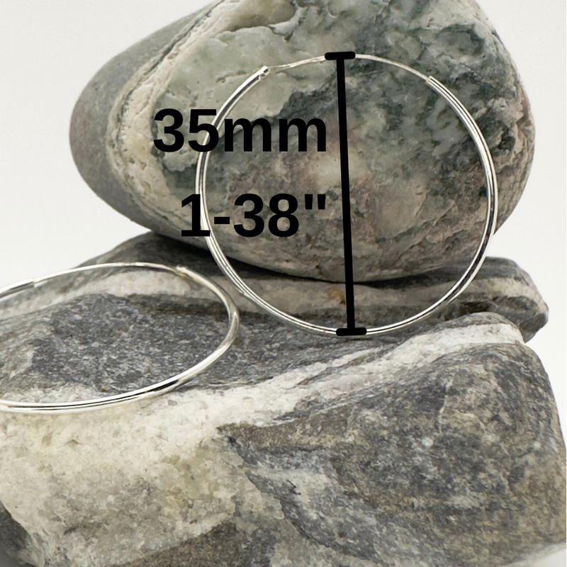 Load image into Gallery viewer, Two silver hoop earrings on a rock with measurement text
