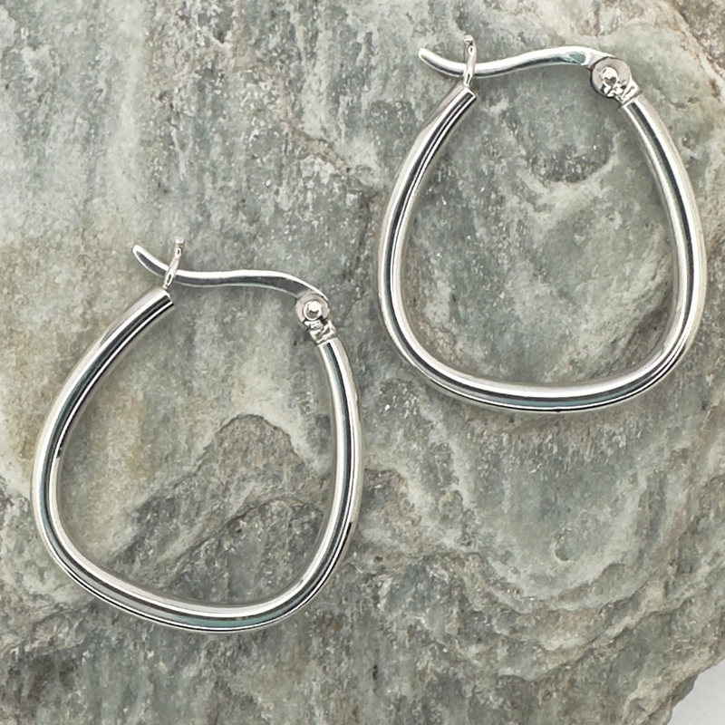 Load image into Gallery viewer, Silver hoop earrings on a textured stone surface
