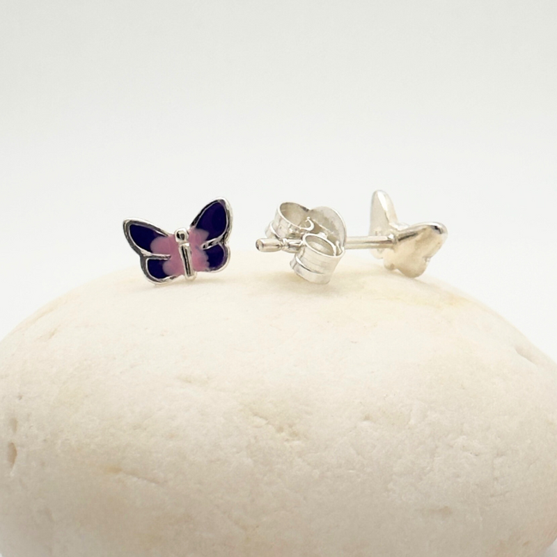 Load image into Gallery viewer, Butterfly-shaped earrings on a white stone with a white background
