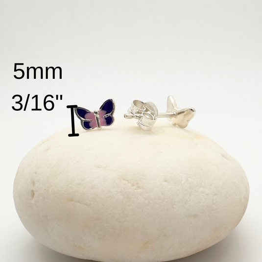 Butterfly-shaped earrings on a white rock with measurement text