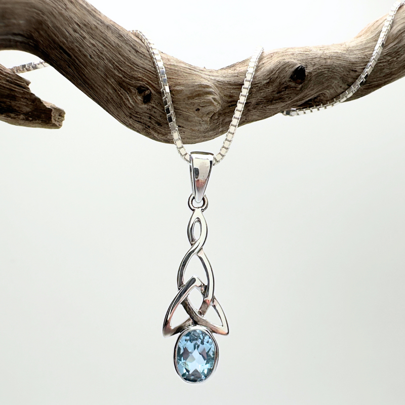 Load image into Gallery viewer, Silver pendant with a blue gemstone on a white background
