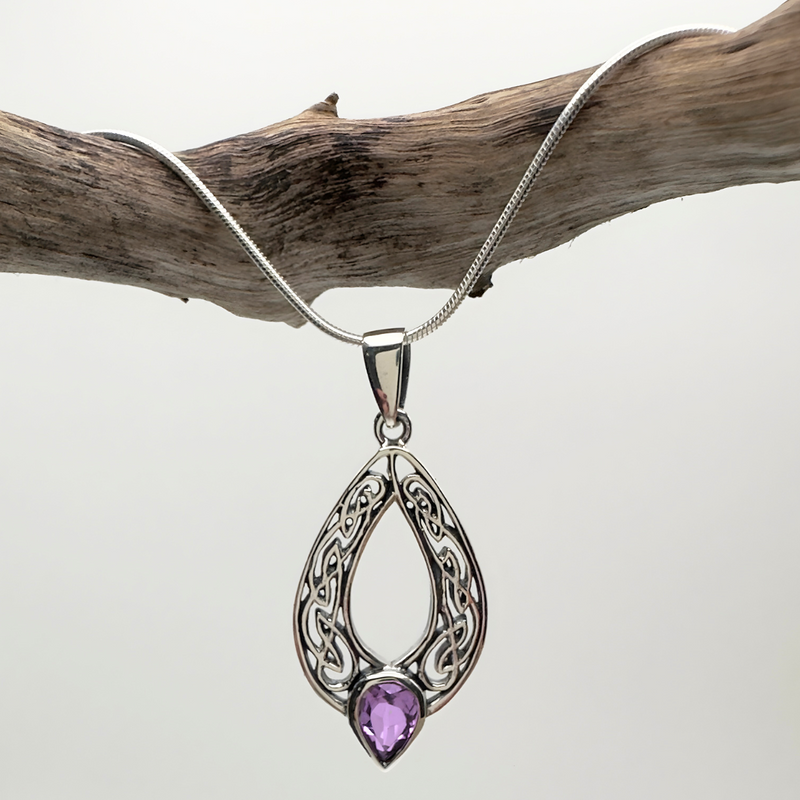 Load image into Gallery viewer, Silver pendant with a purple gemstone on a white background
