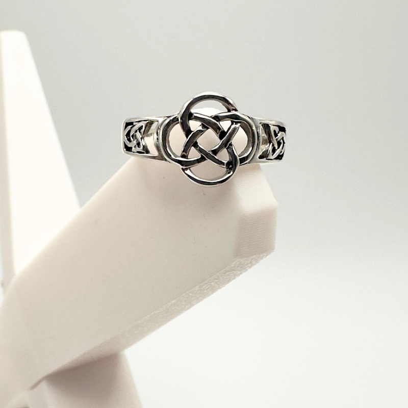 Load image into Gallery viewer, Silver Celtic knot ring on a white mannequin hand against a light gray background
