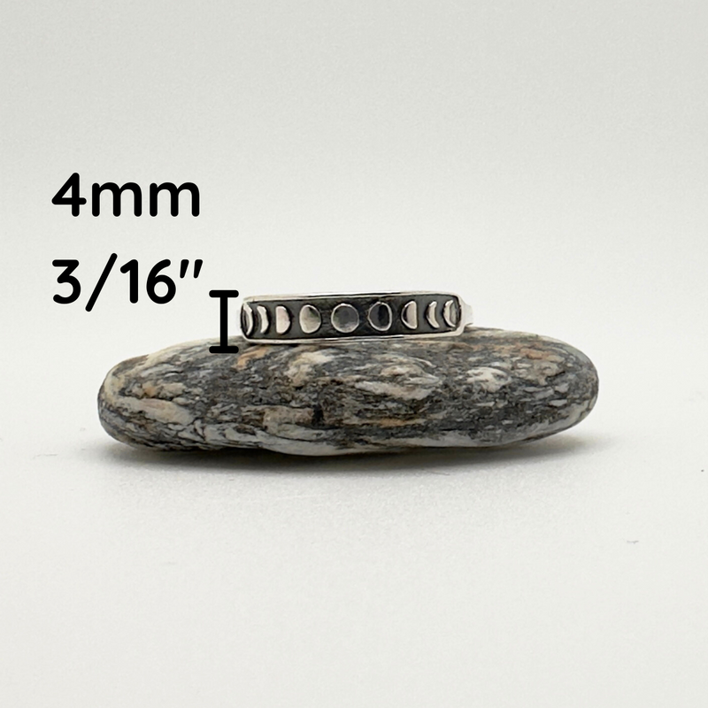 Load image into Gallery viewer, Silver ring on a rock with measurement text &#39;4mm&#39; and &#39;3/16&quot;&#39;.
