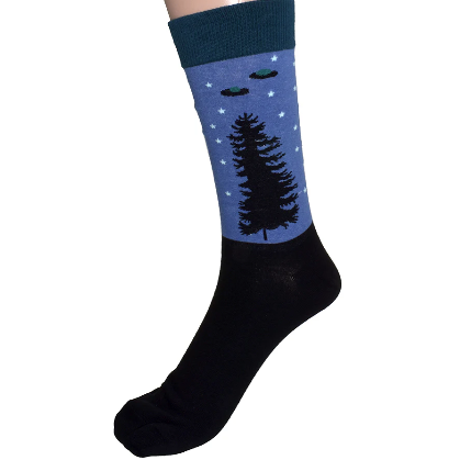 Black sock with a blue section featuring trees and stars on a white background