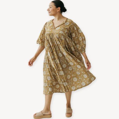 Woman wearing a patterned dress on a white background